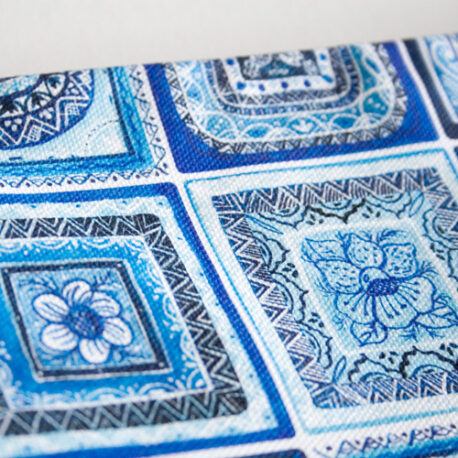The little bags feature Made by Ilze's hand painted folk art tiles in hues of blue on white.