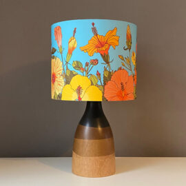 Table lampshade featuring tropical hibiscus flowers in a sunset palette